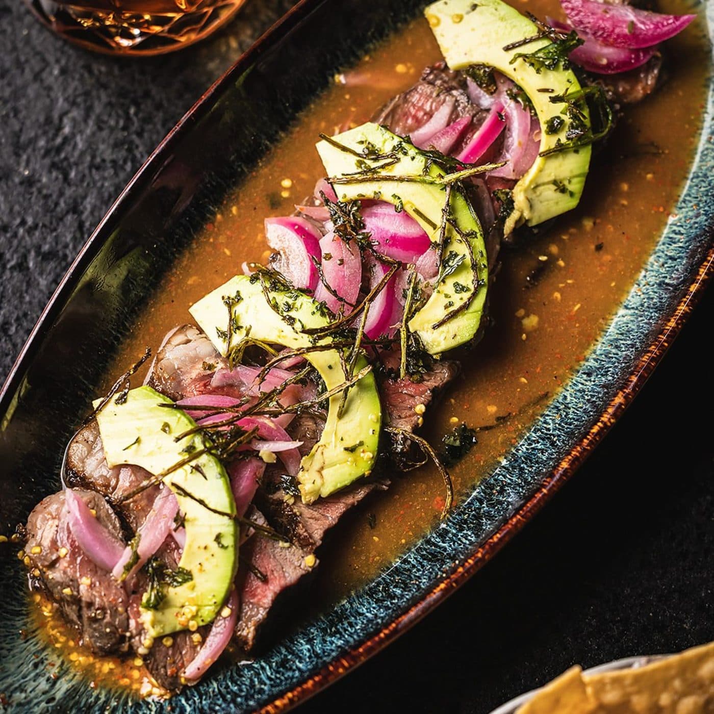 Miel de Agave ribeye aguachile with avocado and pickled red onion